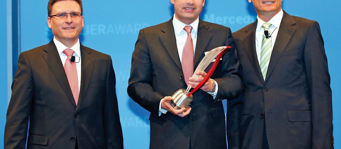 Jürgen Otto, CEO of the Brose Group (center) accepts the